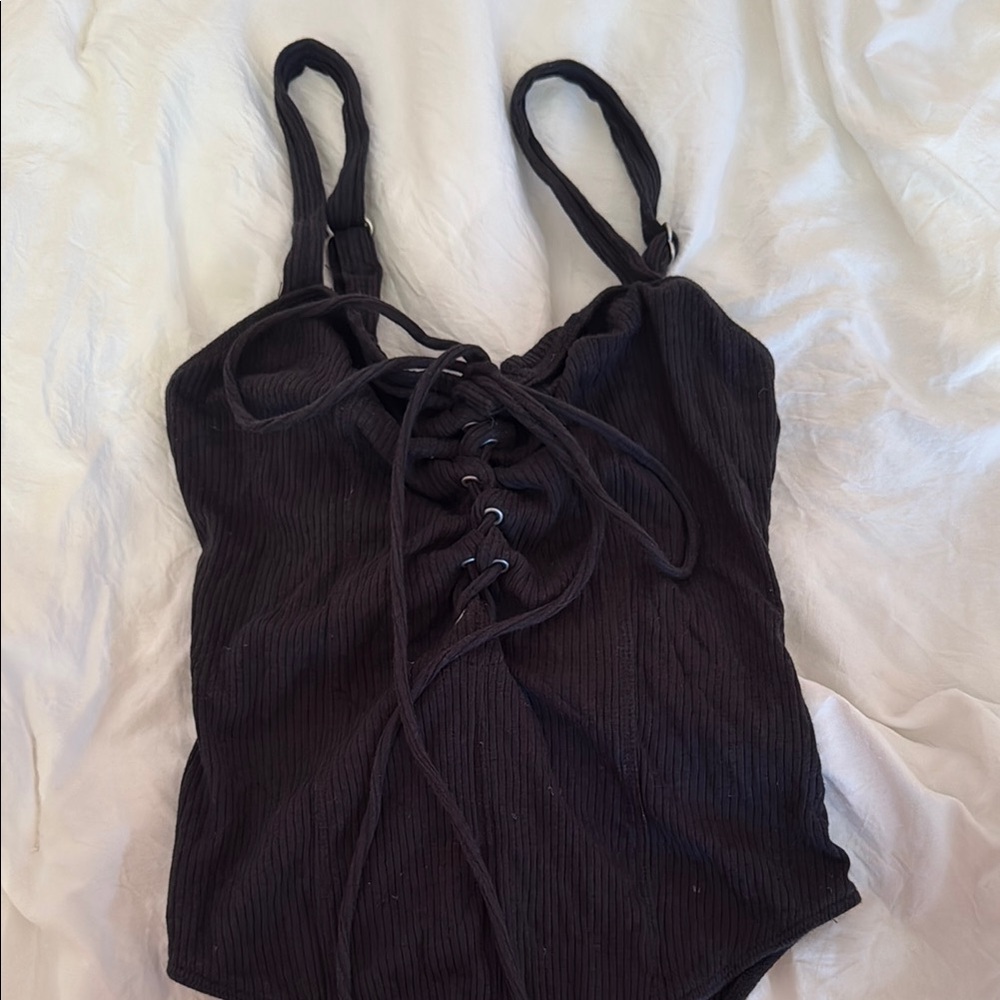 Black sleeveless bodysuit with sweetheart neckline and tie front detail
